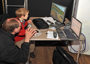 Young visitor to the VLT movnig woodlands and wind turbines in virtual model of Methlick area