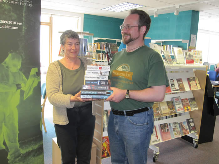 Stuart presenting a set of his book to the librarian in Ullapool