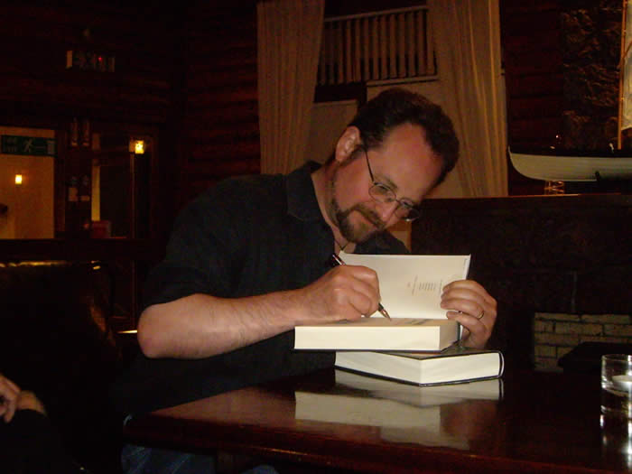 Stuart signing books